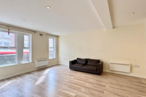 Spacious contemporary living area with bright w...