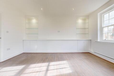 Bright modern living room with sleek shelving...