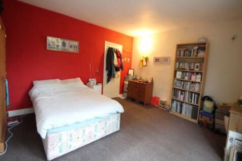 A spacious and welcoming double bedroom with a ...