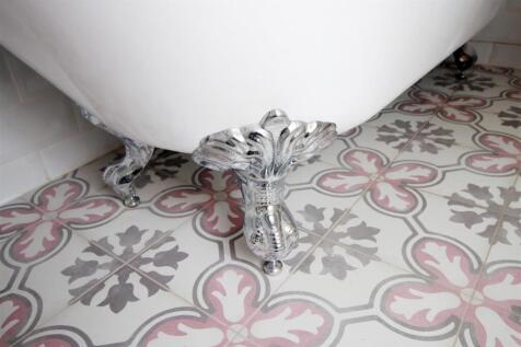 Elegant roll top bath and patterned floor tiles...