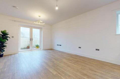 Bright, modern living room with light wood floo...