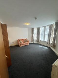 Bright, expansive living area with bay windows...