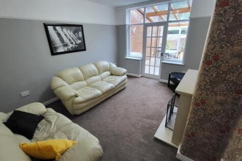 A bright and welcoming living room featuring co...