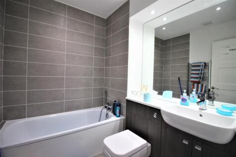 Modern bathroom suite with sleek grey tiling...