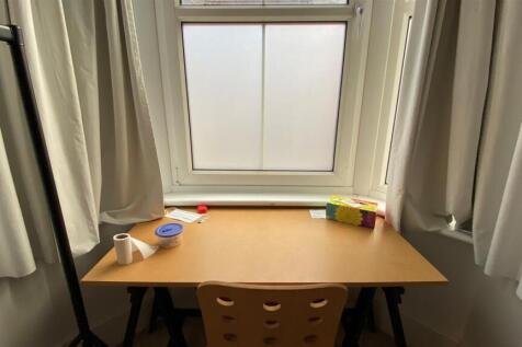 Bright workspace with a large window and desk...