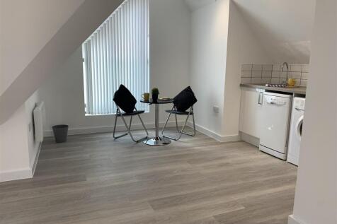 Bright open-plan living area with kitchenette...