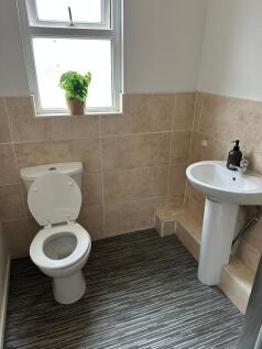 Bright and clean bathroom featuring a toilet an...