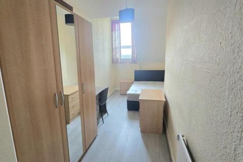 Compact bedroom with wardrobe, desk and natural...