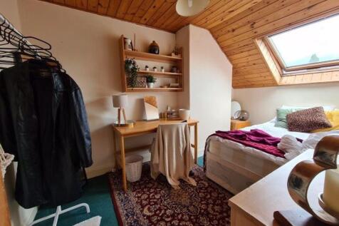 Bright and cozy master bedroom featuring a slop...
