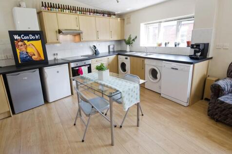 Bright, modern kitchen with light wood cabinets...