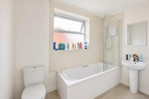 Bright and airy bathroom with a full-size tub...