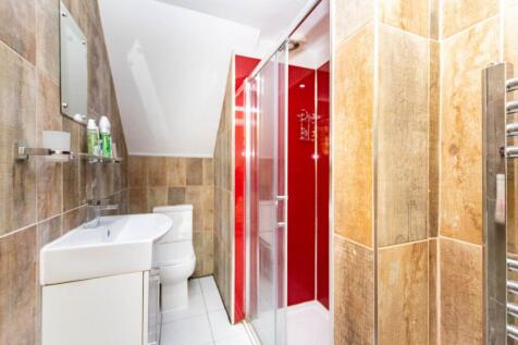 A modern bathroom featuring a small sink unit, ...