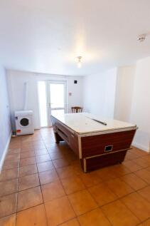 A simple kitchen area featuring a game table or...