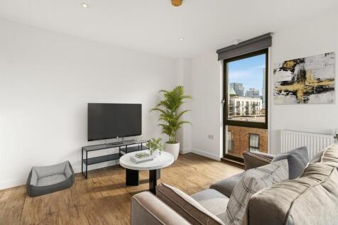 Enjoy urban living in this stylish and cozy living room with expansive city views.