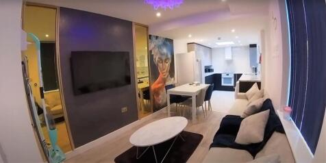 Contemporary lounge with TV, sofa and coffee ta...