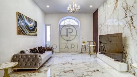 Sophisticated living room with marble flooring, a 