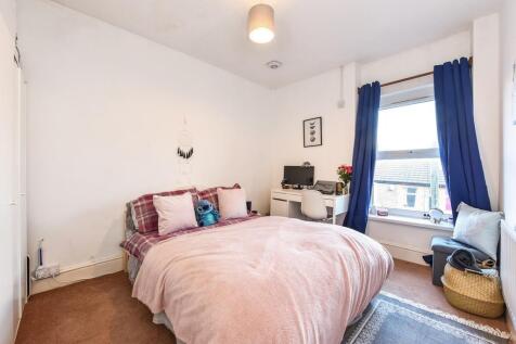 Bright bedroom with large window and study desk...