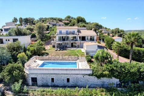 A spacious hillside villa with a large swimming po
