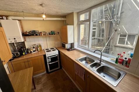 A spacious and well-lit kitchenette with modern...