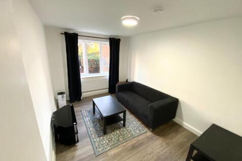 Bright, freshly painted living room with a larg...