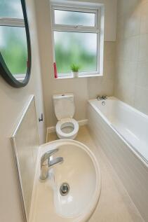 Bright modern bathroom with bath and window...