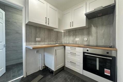 Modern fitted kitchen with wood worktops...