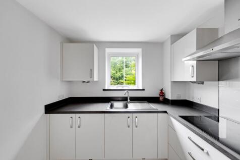 a kitchen with white cabinets