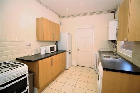 Bright and modern kitchen featuring ample stora...