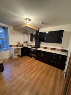Spacious kitchen with modern black cabinetry...