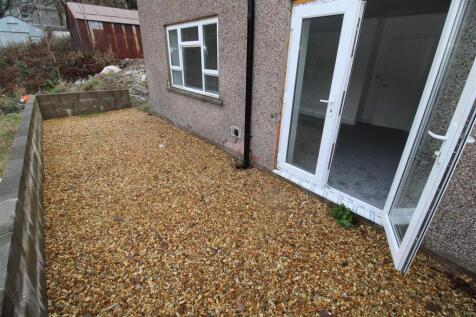 Private low-maintenance gravel patio area...