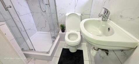 Modern shower room with elegant marble tiling...