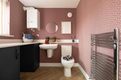 A guest cloakroom also offers utility space