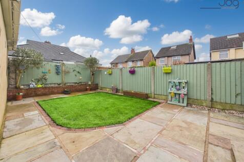 A private, low-maintenance garden with paved patio, neat central lawn and space for outdoor dining.