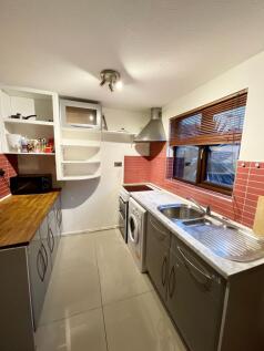 A bright and tidy kitchen with modern appliance...
