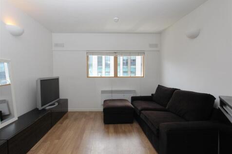 Bright lounge with comfy sofa and wooden floors...