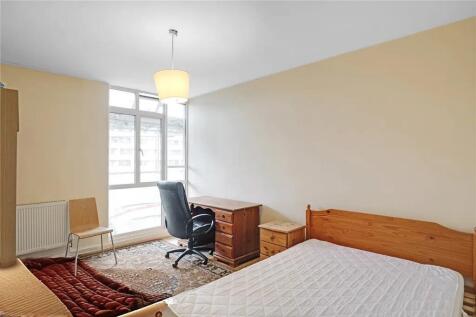 Bright bedroom with large window and study desk...