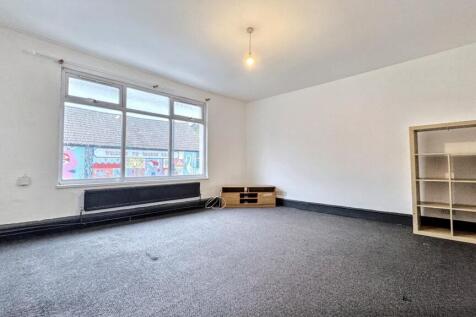 Spacious bright living area with large window...