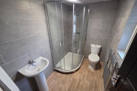 Modern tiled bathroom with sleek corner shower....