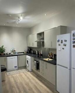 Bright, modern galley kitchen with light cabine...
