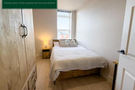 Bright bedroom with double bed and ample storag...