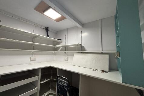 Bright study area with extensive shelving stora...