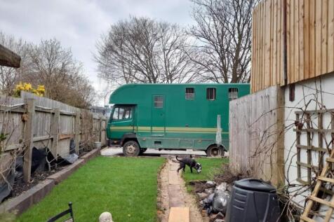 The huge lorry parked in the garden, demonstrates 