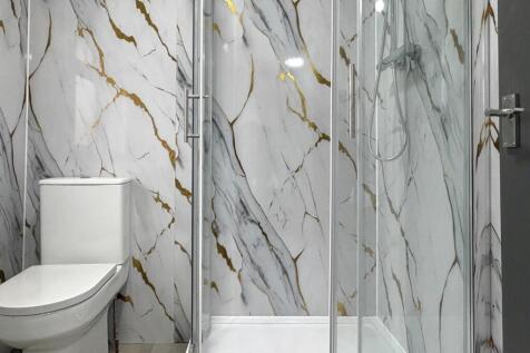 Modern bathroom with a glass-enclosed shower an...