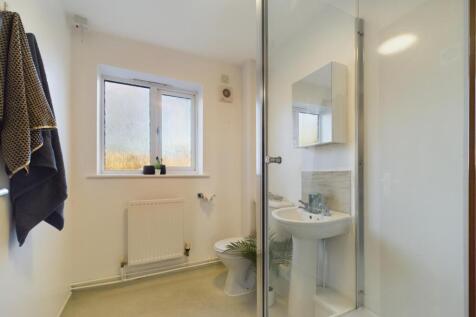 A modern and bright bathroom featuring a spacio...