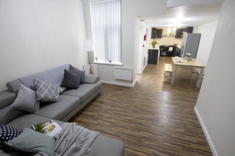 Bright and spacious living area with modern dec...