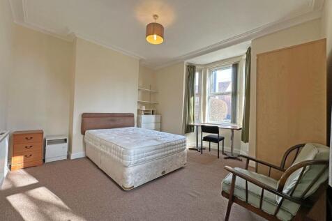 Spacious bedroom with bay window and study desk...