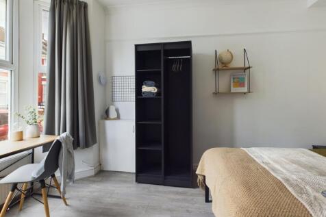 A bright and inviting double bedroom featuring ...