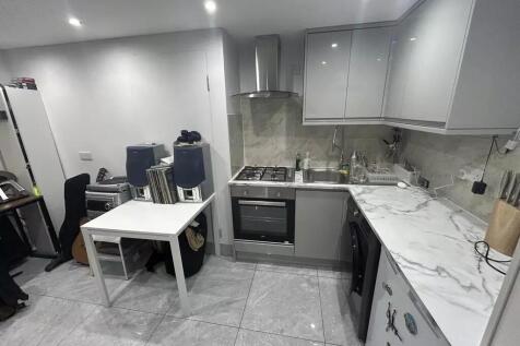 Modern grey kitchen with sleek marble counters...
