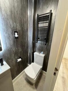 Modern small bathroom with a sleek close-couple...