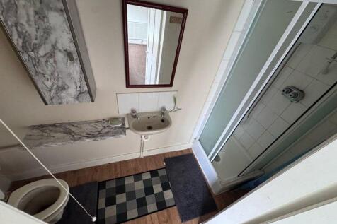 A neat bathroom featuring a walk-in shower with...
